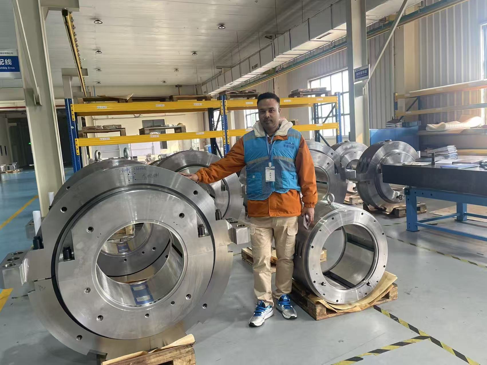 Swiftpath representative at a Chinese industrial OEM during in-person inspection of large CCPP bearing housings