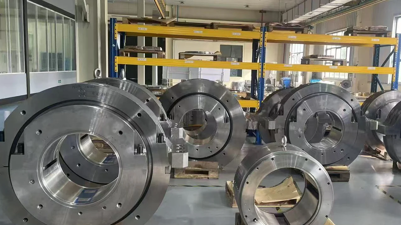 Large industrial radial and thrust bearing assemblies on a China factory floor during procurement review